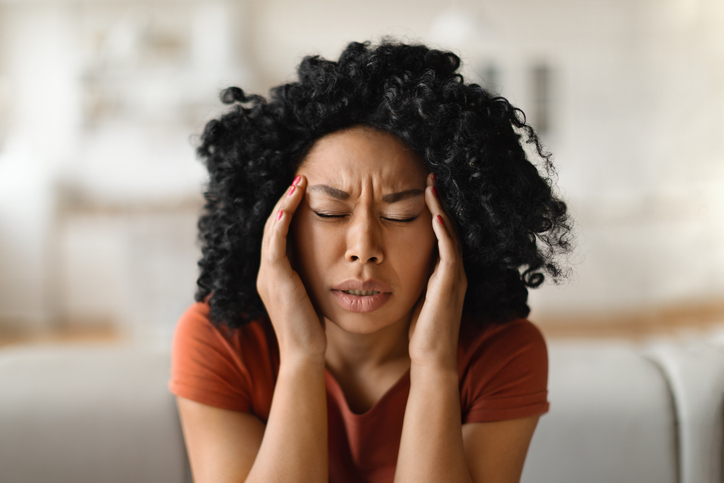 pregnant woman experiencing headache-inducing stress