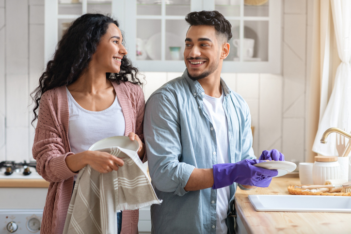 couple washing dishes together