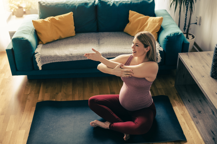pregnant woman stretching her triceps