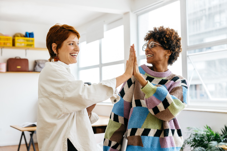 two women high-fiving