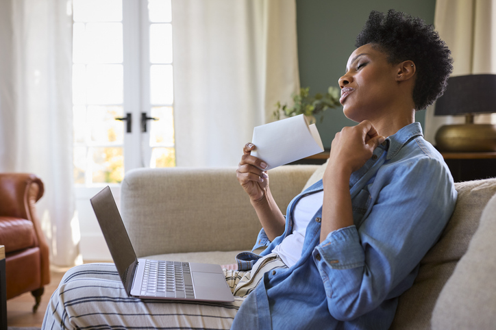 woman fanning herself during a hot flash