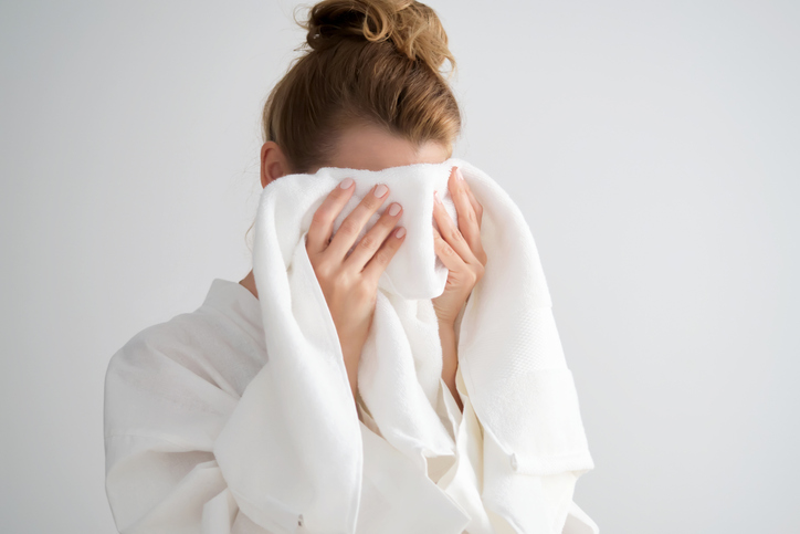 woman toweling off her face