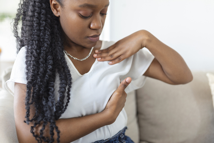 woman doing a breast self exam