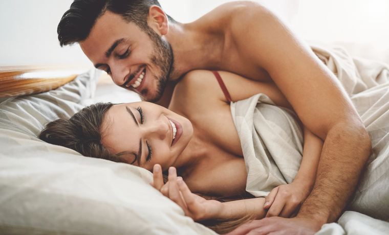 man initiating sex with his partner in bed