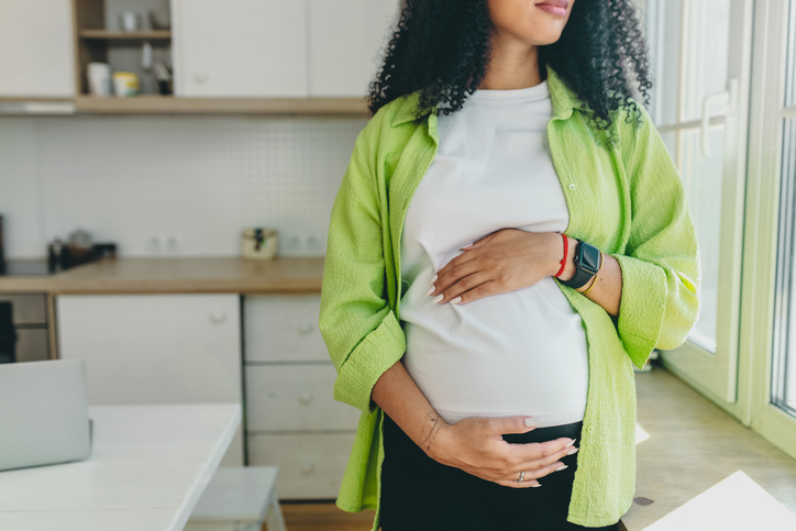 pregnant woman holding her belly