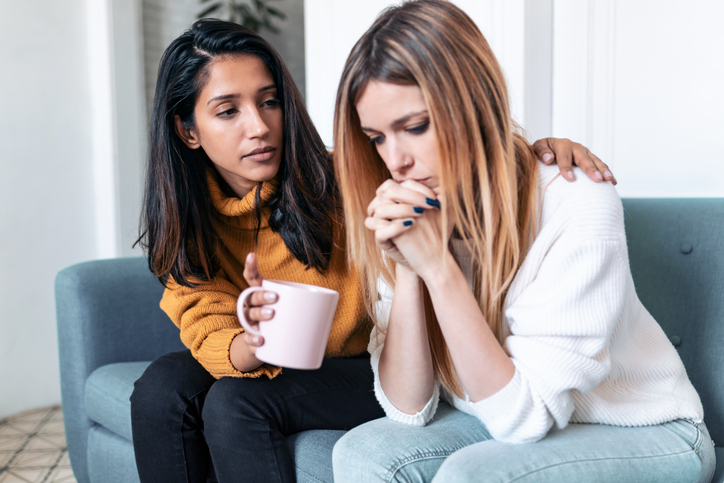 woman comforting her friend in distress