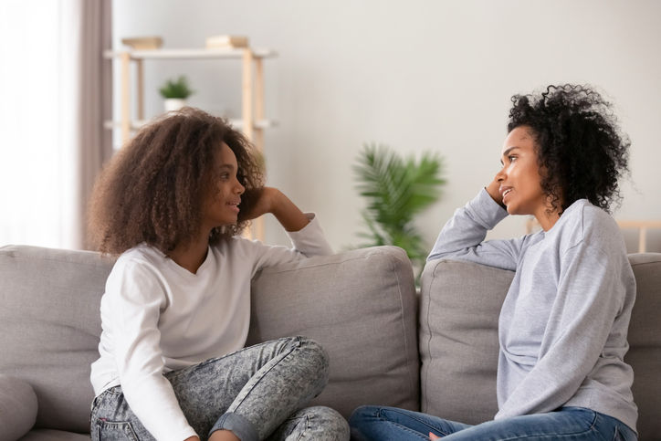 two friends chatting on the sofa