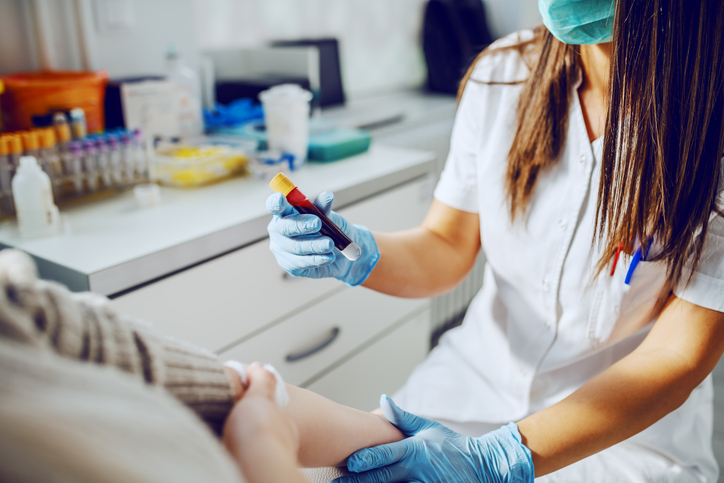 lab technician holding a blood sample