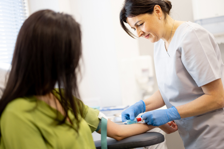 lab tech drawing blood for a complete female hormone panel