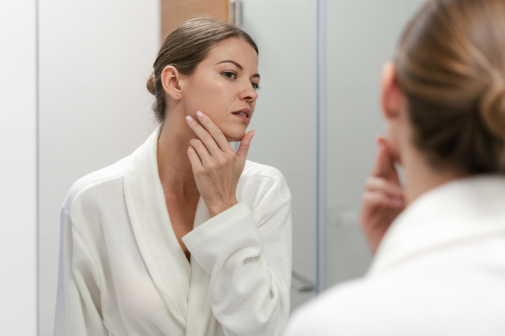 woman examining her facial hair