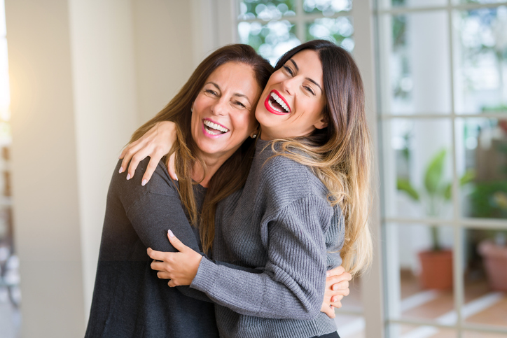 mom and adult daughter hugging