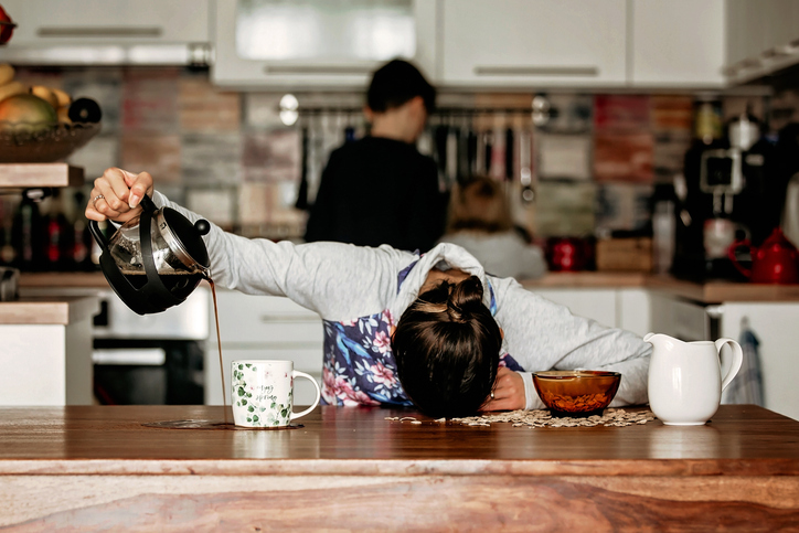women who is pouring coffee all over the table due to fatigue