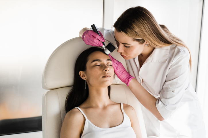 doctor examining a woman's skin