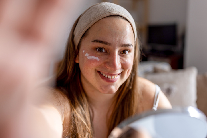 woman treating her acne-prone skin