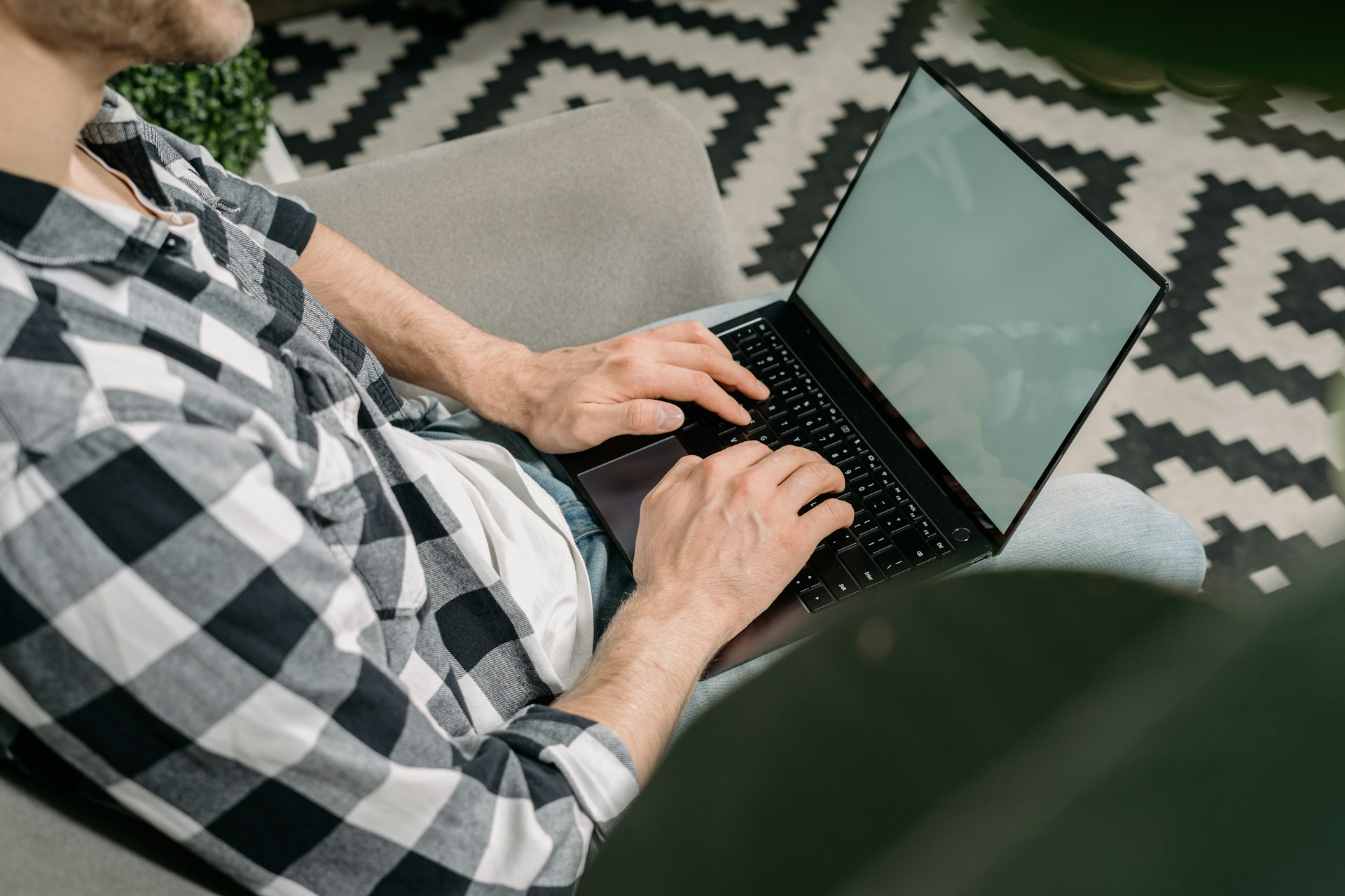 man researching sperm freezing on his laptop