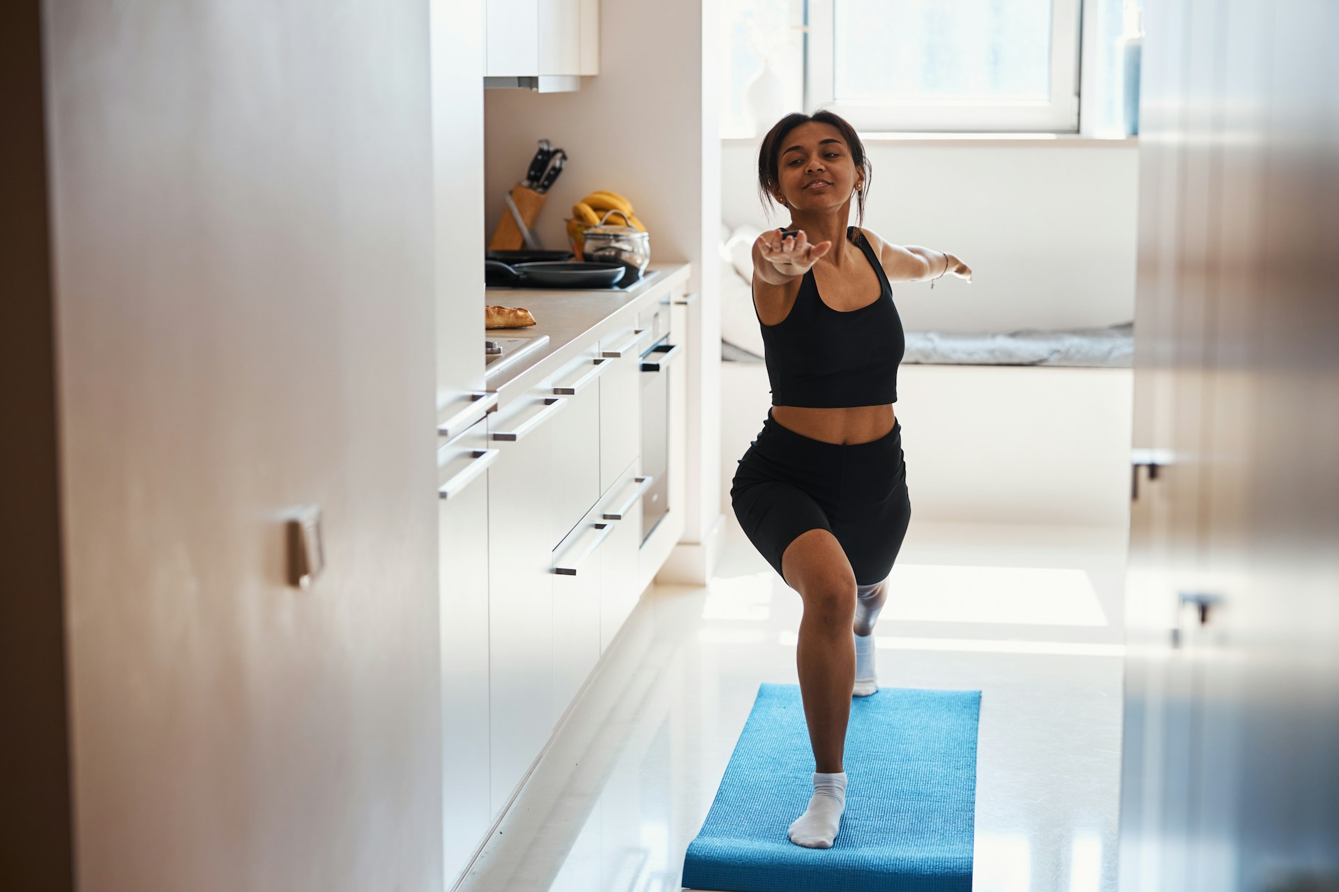 woman doing yoga in her kitchen