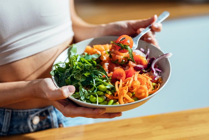woman eating a colorful salad