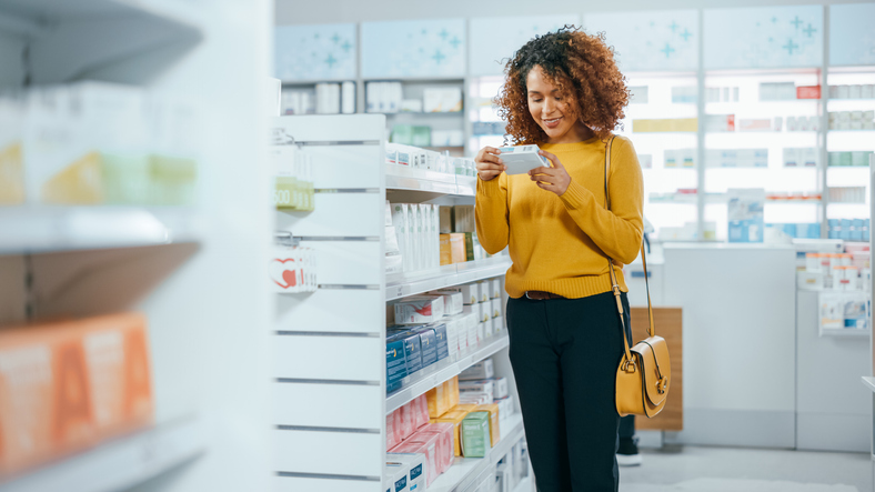 woman looking at a box of tampons