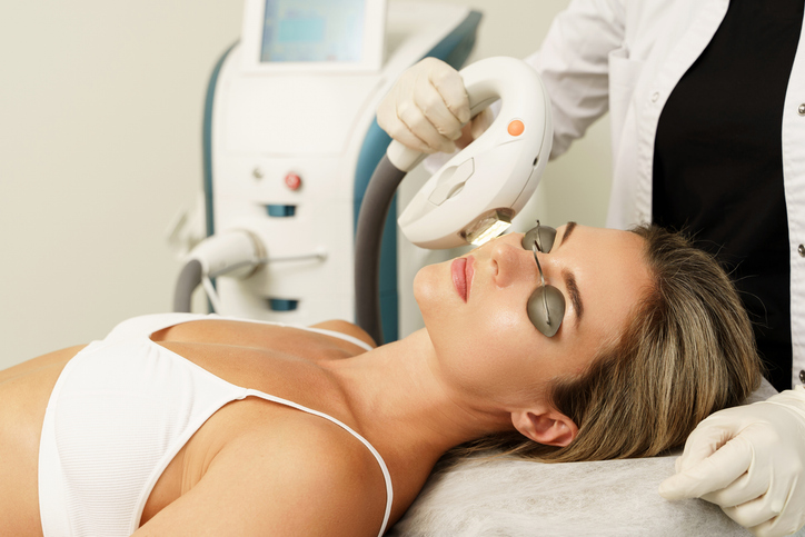 woman getting laser hair removal on her face