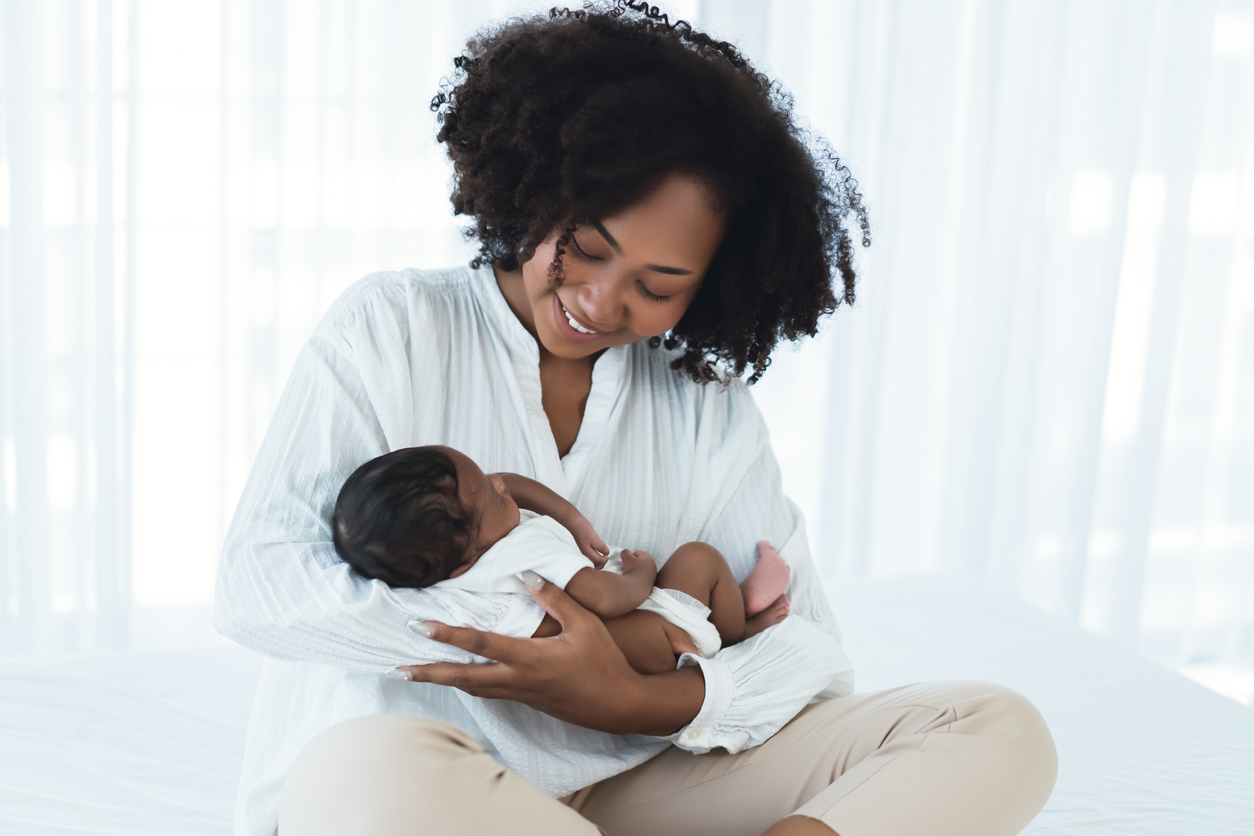 woman cradling her new baby