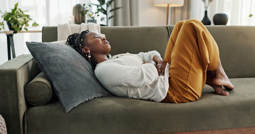 woman with endo pain cradling her abdomen