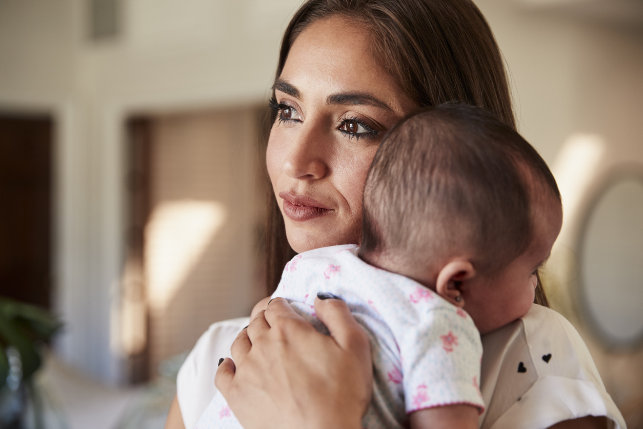 woman burping her new baby