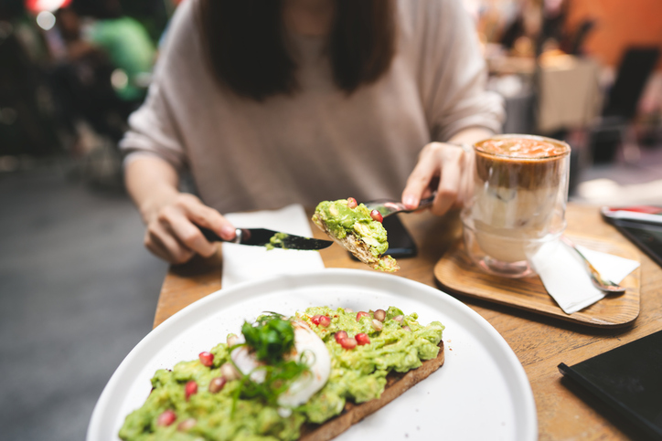 woman eating avocado toast