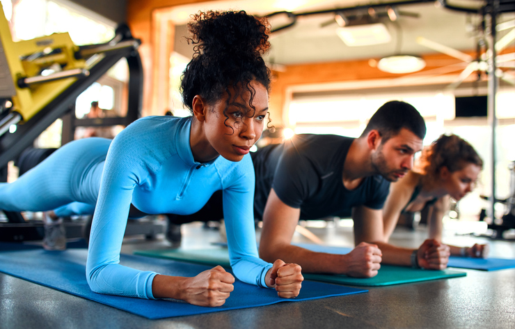 people holding plank in a workout class