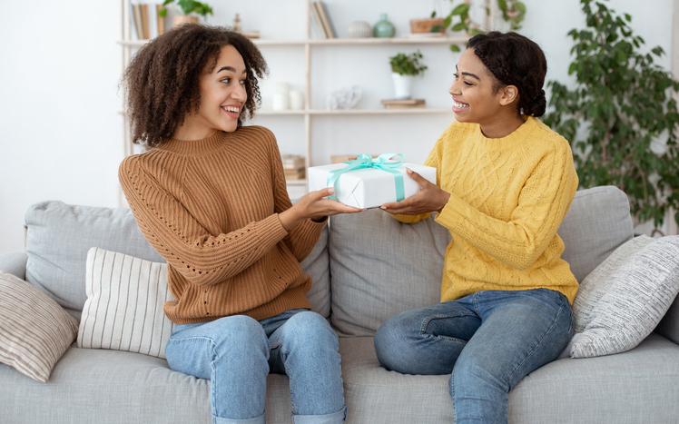 friend giving her friend a new mom gift
