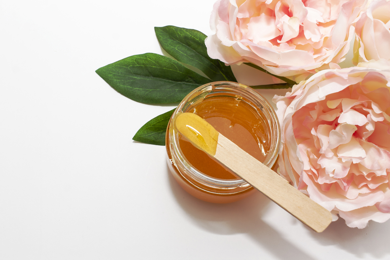 pot of wax nestled near peonies