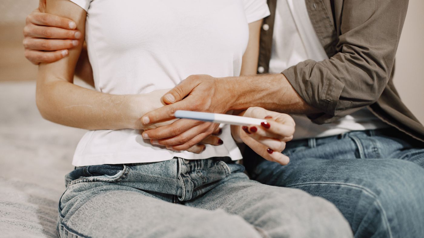 couple looking at the results of a pregnancy test