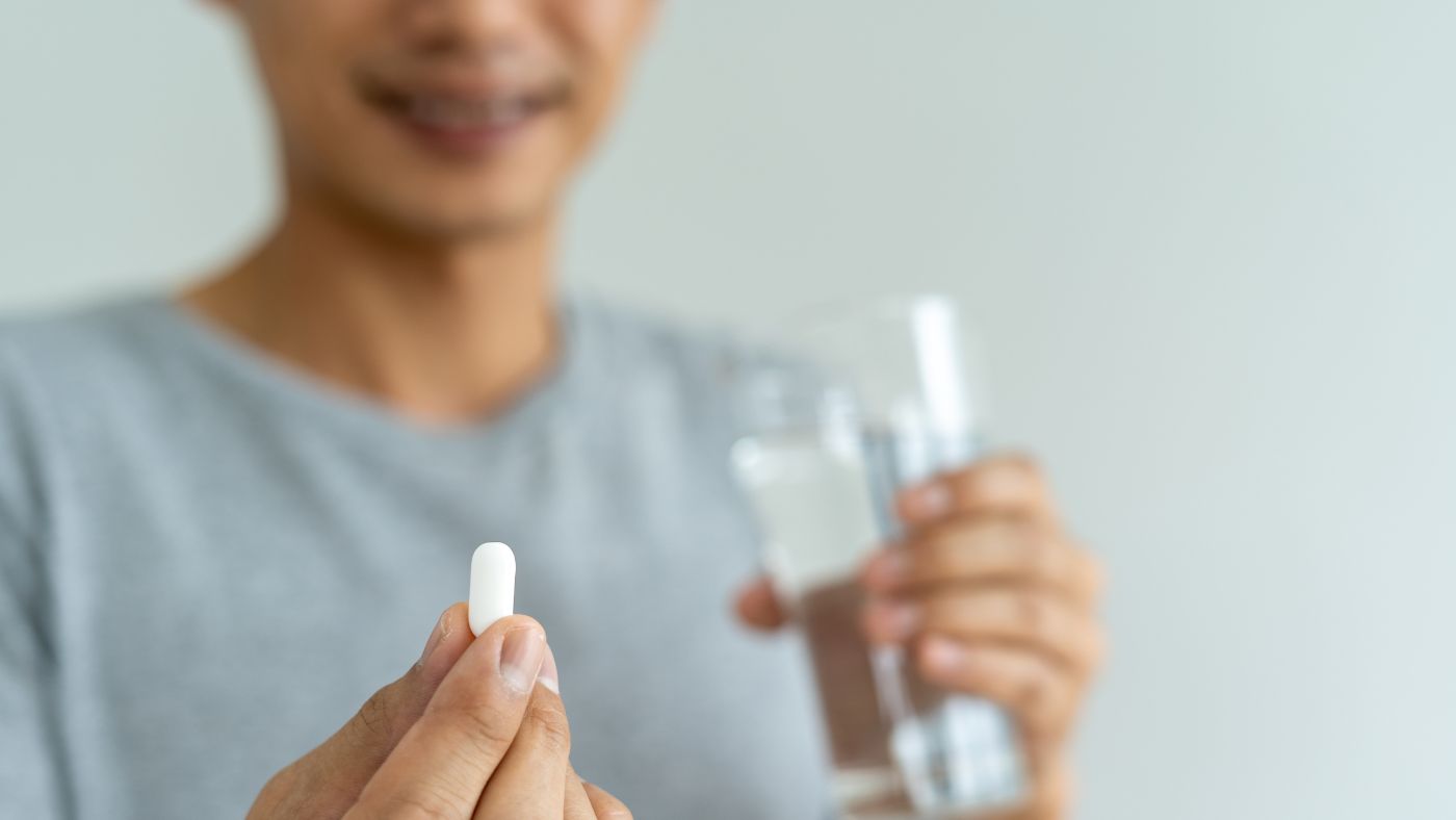 woman taking supplements to boost fertility
