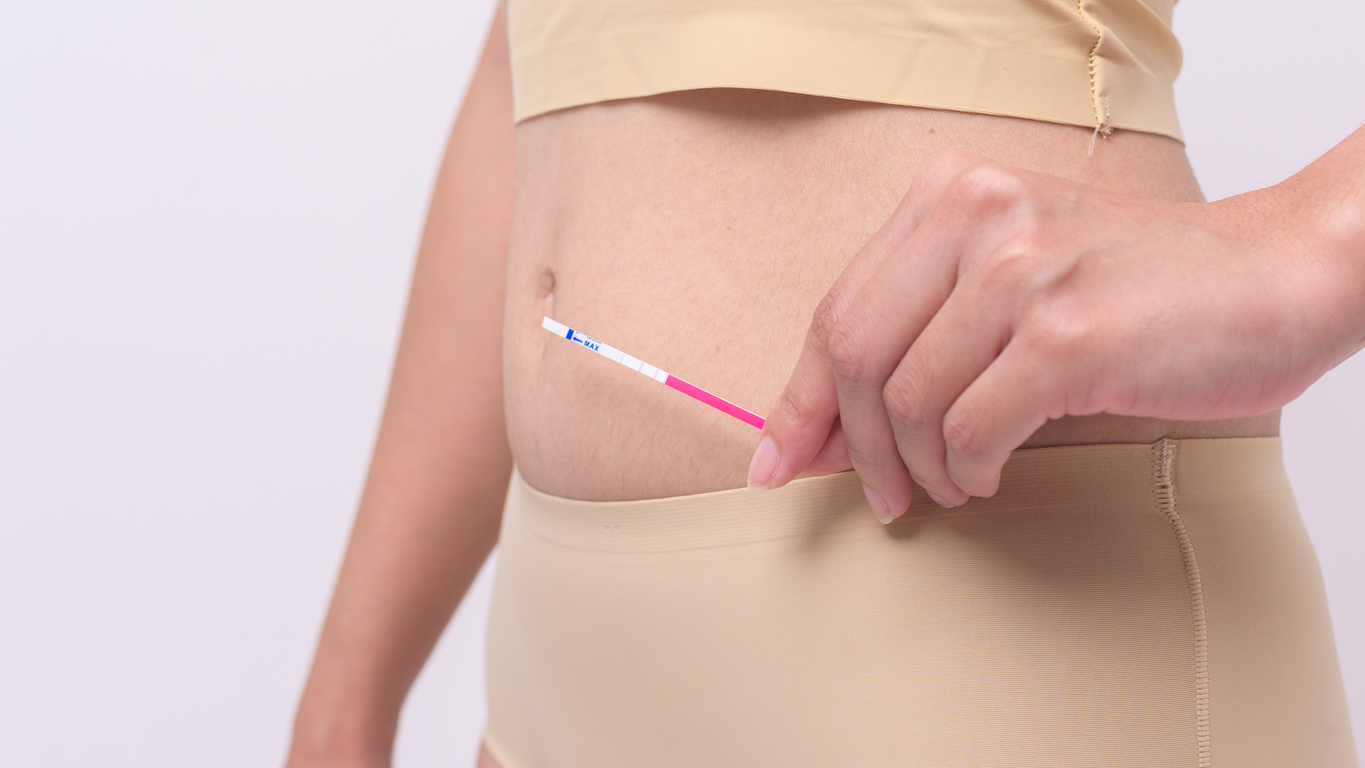 woman holding an ovulation test strip