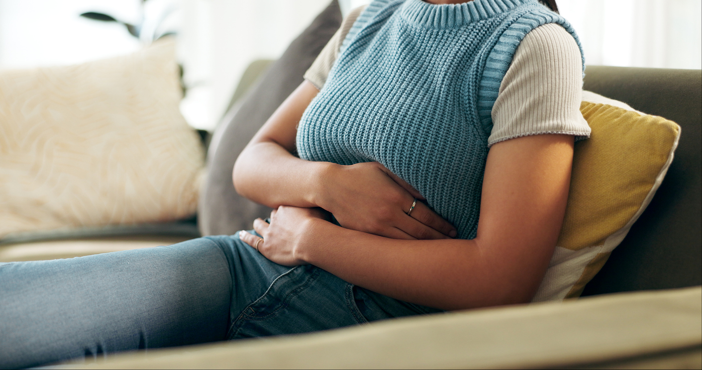 woman clutching her belly after miscarriage