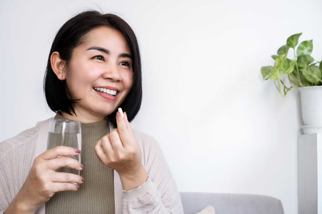 woman taking supplements to fight perimenopause and fatigue