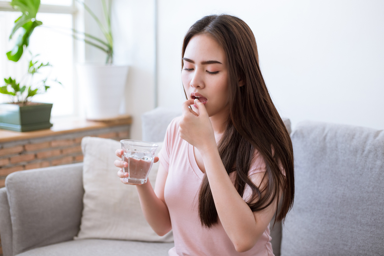 woman taking medication for vaginal burning