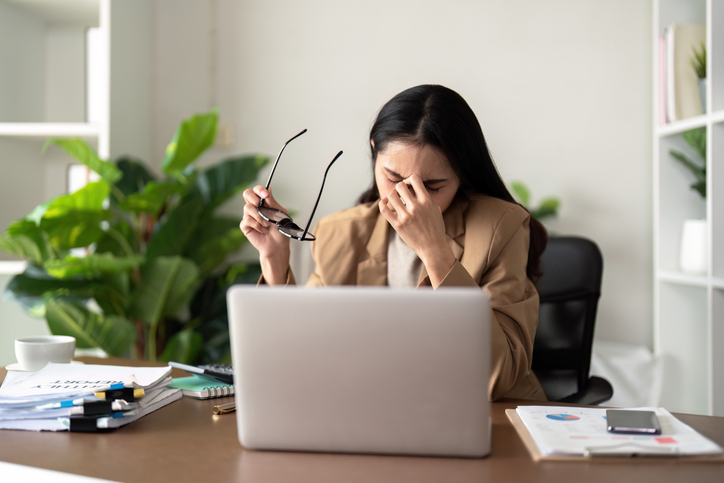 woman suffering from perimenopause fatigue at work