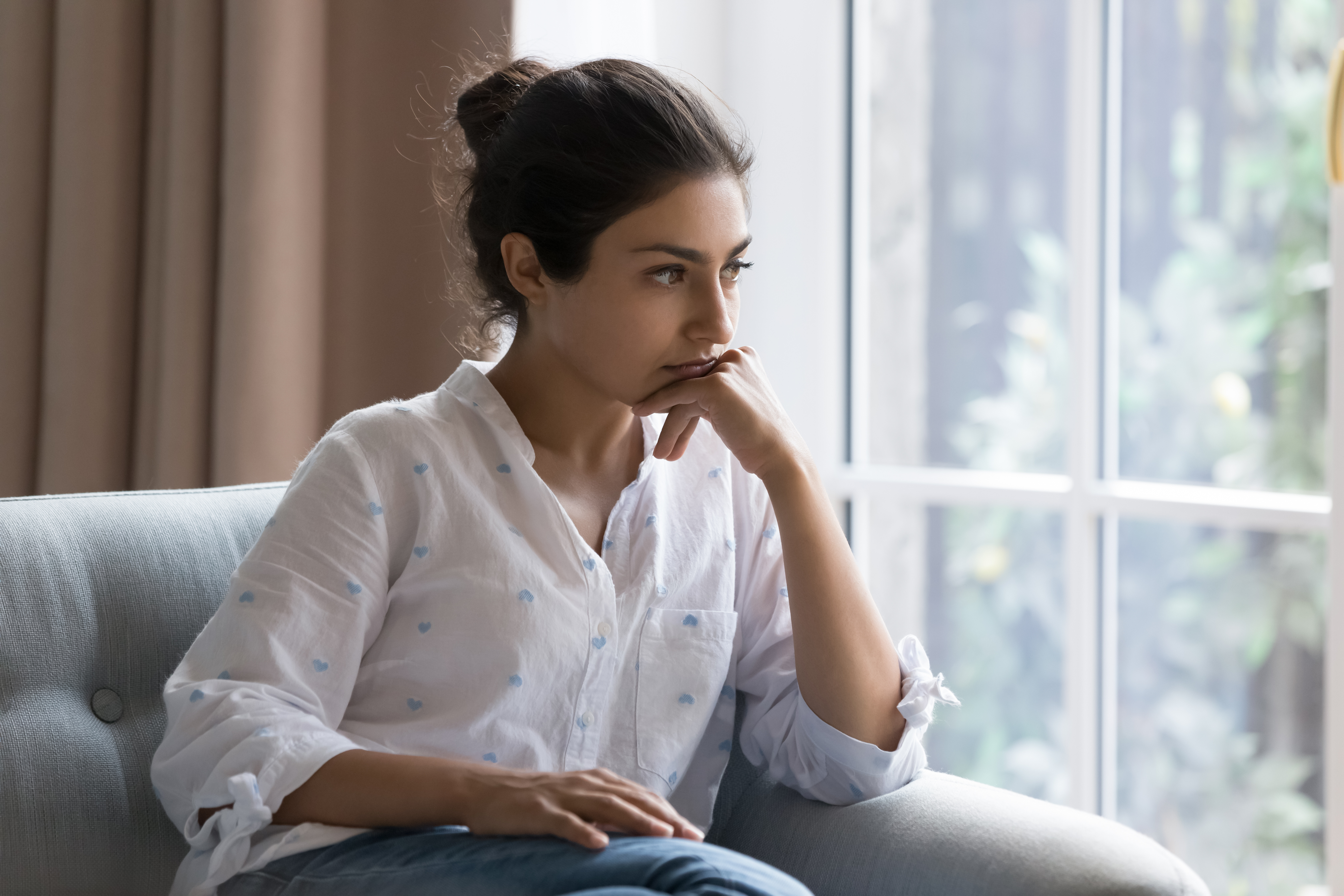 woman thinking on the sofa