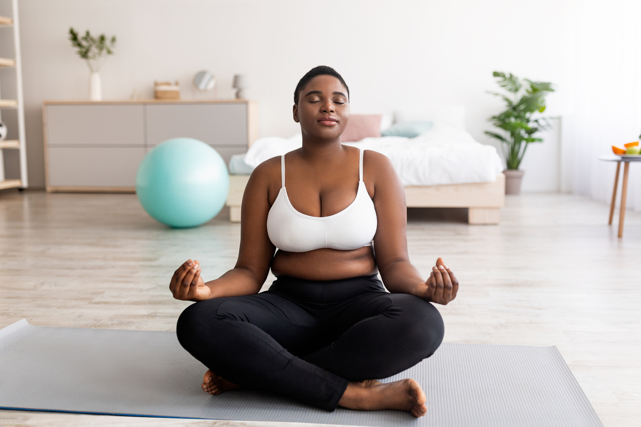 woman meditating in her bedroom