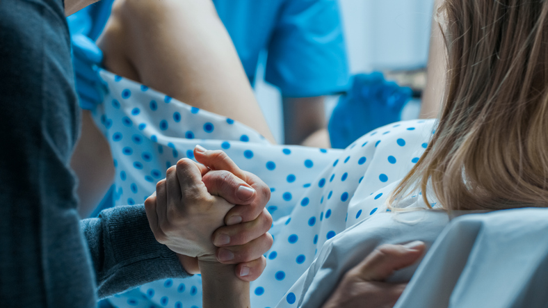 woman delivering a baby vaginally after cesarean