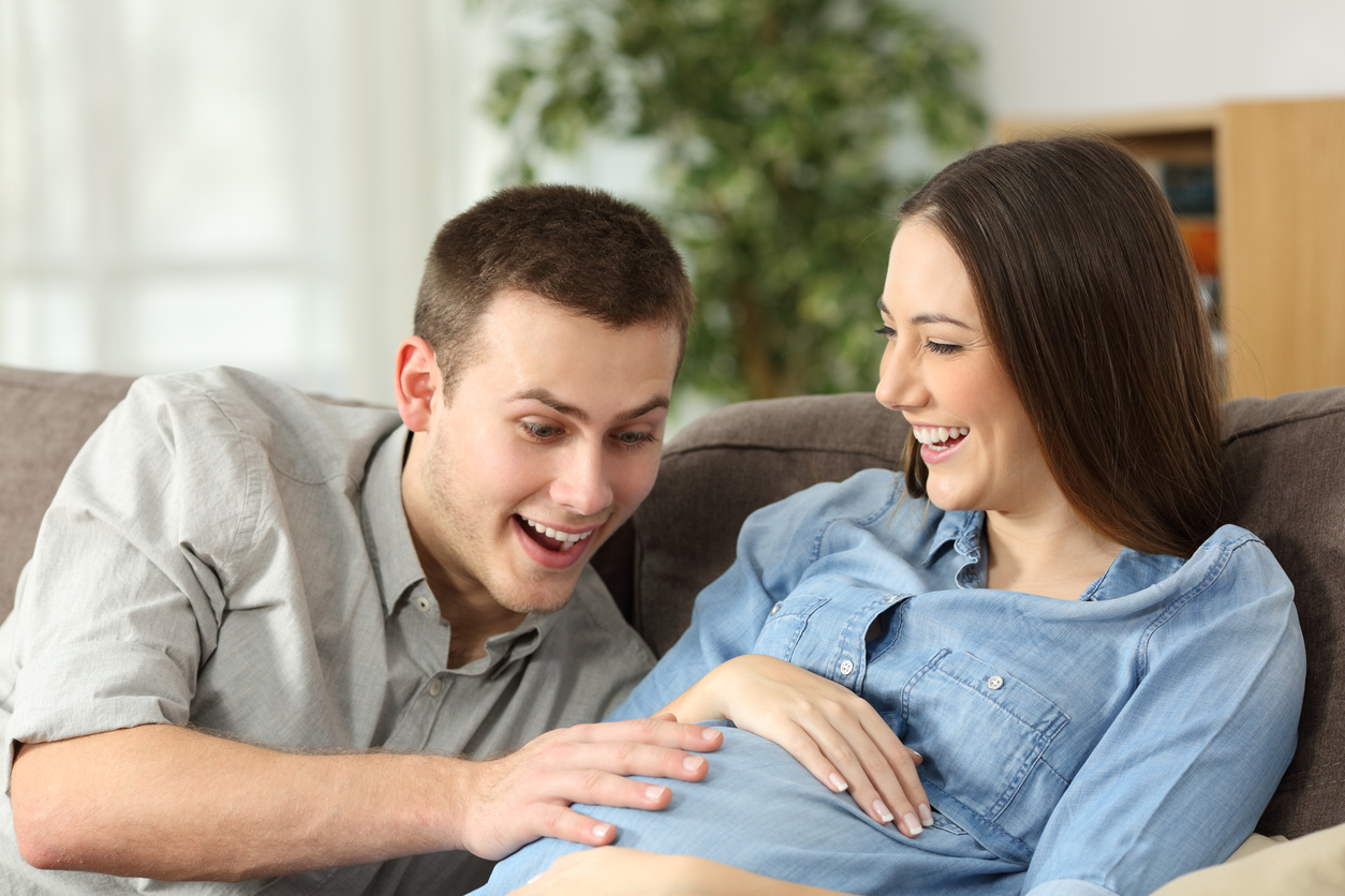 couple feeling their fetus kick