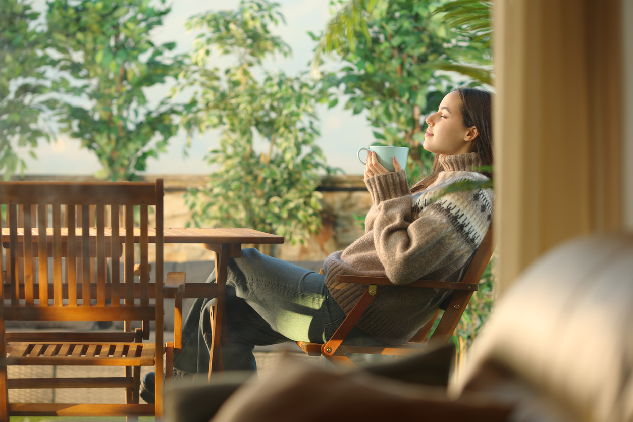 woman drinking tea on the porch