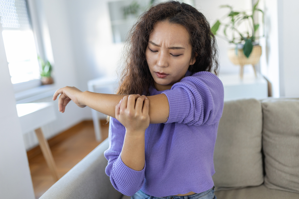 woman having joint pain in her elbow during her period