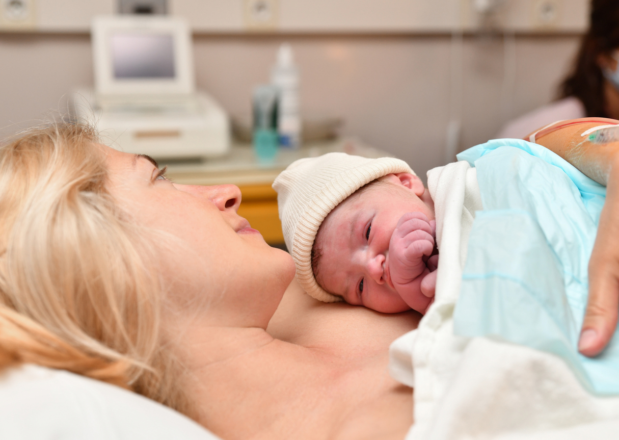 mom resting with her newborn baby in the hospital