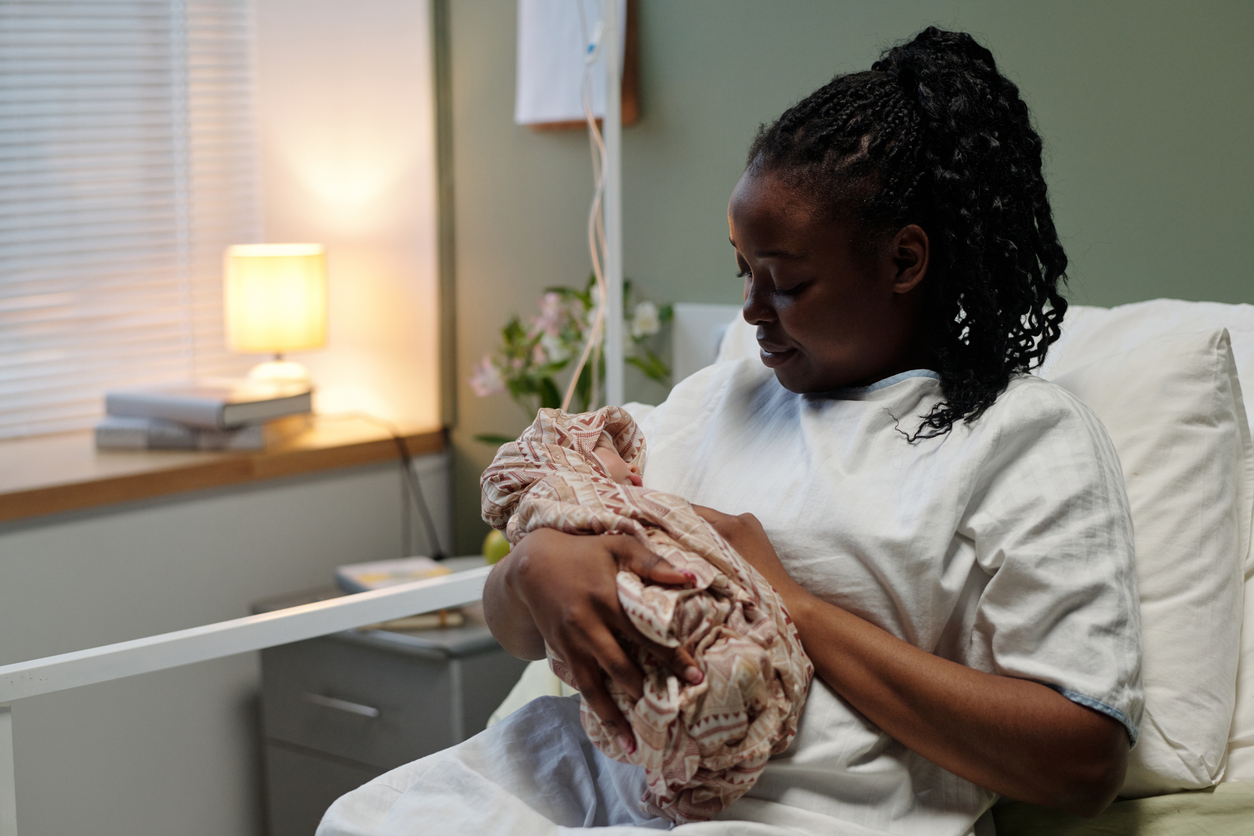 woman cradling her newborn baby