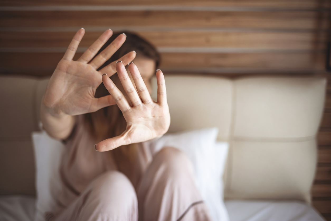 woman putting up hands to avoid painful sex during pregnancy