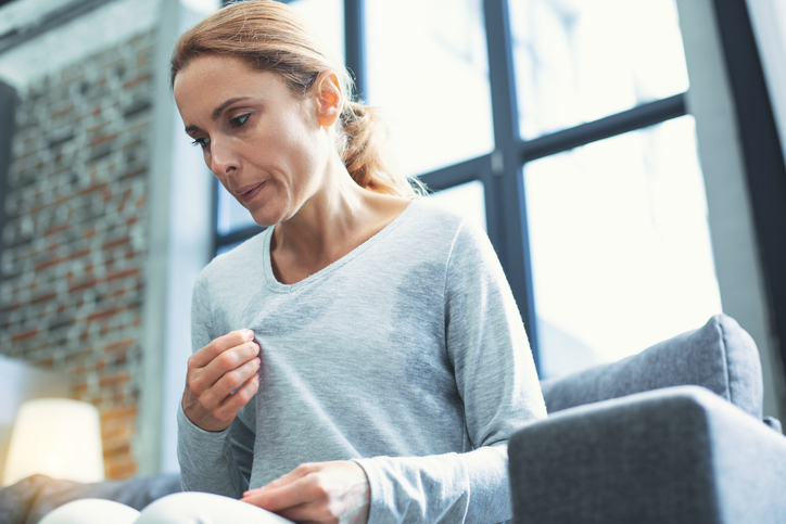 perimenopausal woman having a hot flash before her period