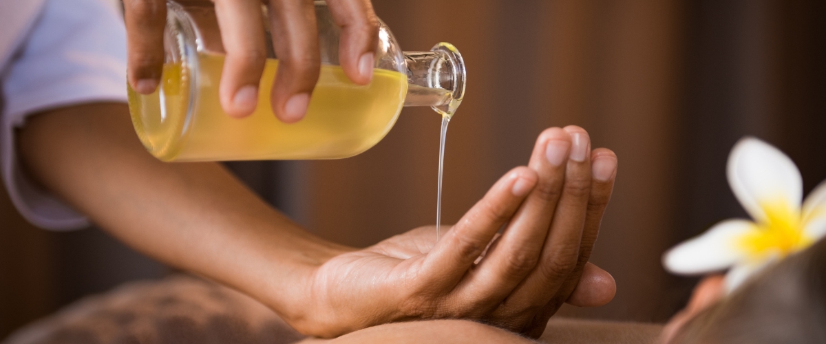 woman pouring castor oil into her hand