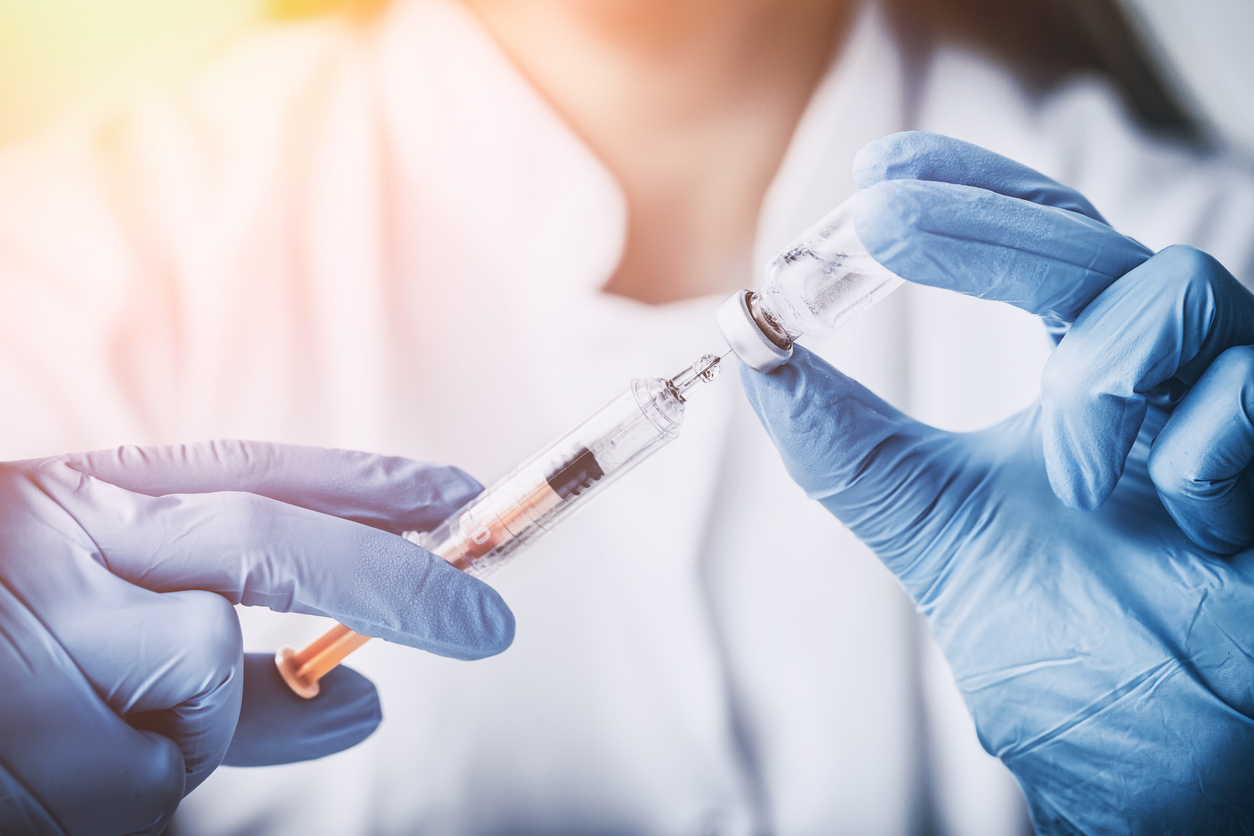 pharmaceutical lab technician holding a needle