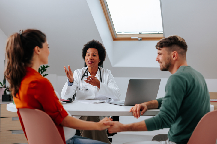 couple talking with a financial counselor at their first fertility clinic visit